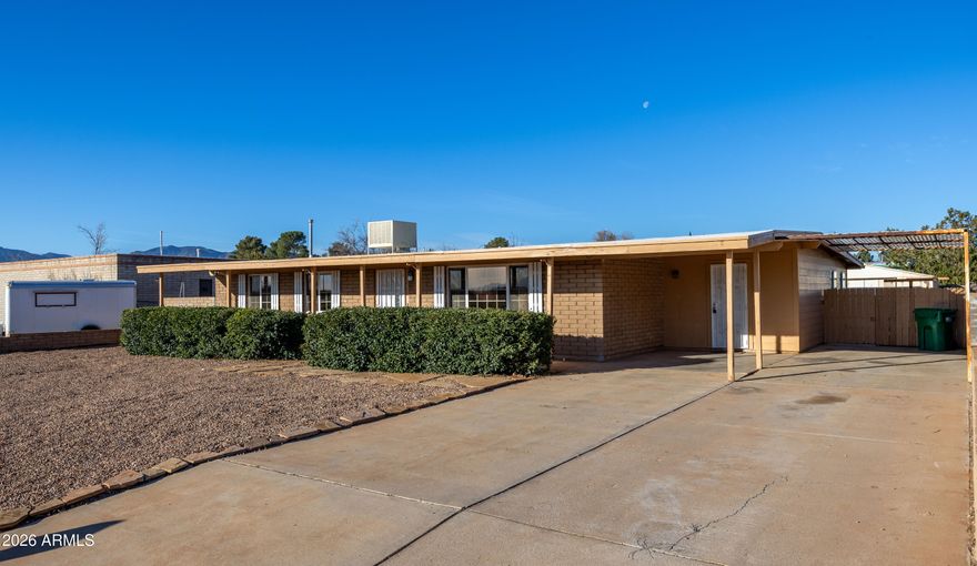 Great location ,one street from east range. porch swing to take in views. All tile floors except new carpet in sun room that is all windows, next to 4th bedroom that is better used as nice office space. Kitchen opens to carport for easy unloading of grocries. Lots of cabinets for storage. gas stove and up scale refidgerator. Primary bedroom is large .  Square footage is closer to 2000 as minisplits are added to sunroom and 4th bed/office room.  All in the desireable Tombstone School destrict.  Block wall around back and lower one in front. Mastercool is cooling system.