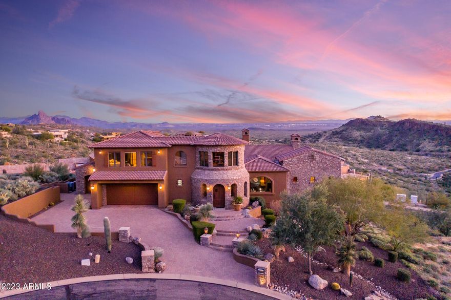 Exquisitely appointed and extraordinarily designed, this property is a Trophy among Fountain Hills' finest estates. Tucked on a corner lot of a quiet cul-de-sac within the coveted gated community of Crestview, enjoy the ultimate privacy and endless views of sparkling city lights, mountain ranges, and the world below. Pass through the tranquil courtyard and step inside to instantly notice soaring ceilings, designer finishes, and breathtaking views beyond pocketing walls of glass. Open to the living room, the chefs kitchen is complete with immense slabs of granite, dual sub-zero refrigerators, three separate ovens, built-in espresso machine, a plethora of cabinetry, breakfast bar, and breakfast nook with more built-in views. Regally designed, the oversized master retreat is complete with sitting room, Cantera fireplace, private patio access, dual vanities, posh soaking tub, water closet with bidet, separate walk-in shower, and colossal custom closet. Downstairs, a game room with wet bar and an incredible movie theatre separate this home from the rest. Functional in design, three additional en-suite bedrooms are perfect for guests or loved ones. Additional spaces in the home include a spacious office, formal dining room, main level bonus room with wet bar, full custom wine cellar, and cabinet lined laundry are sure to please. Embrace any Sonoran Season with an incredible main level backyard with ample covered and open air decks, stunning negative edge pool, bubbling spill-over spa, firepit, built in BBQ with bar, and more truly mesmerizing views.