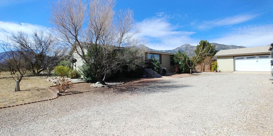 The beautiful home is move in ready and is just waiting for new owners. Located adjacent to Miller Creek you can enjoy the sound of the water running during the monsoons as well as during snow melt.  The home has an amazing mountain view of both the Huachucas and Mule Mountains. There is a lovely split floor plan allowing privacy and the living area is nice and light. The kitchen has ample coutersppace and an island and newer appliances as well. The breakfast nook looks out to the East for amazing sunrises. There is a 2 1/2 car garage with water and a fenced yard. This home also features a VA foundation. This home will definitely not last at this price! Call today to see this home before it is gone!