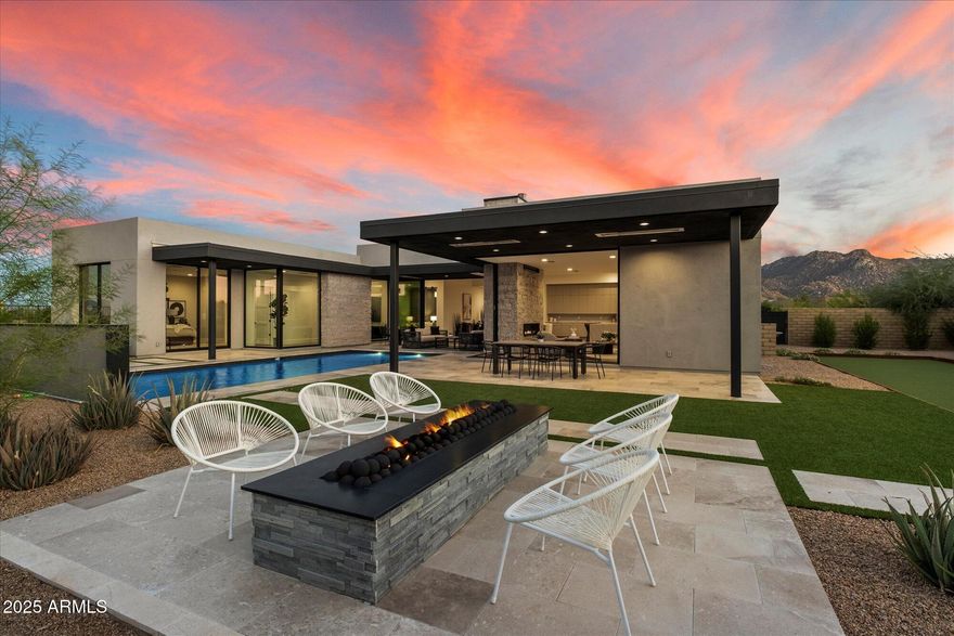 Introducing a coveted Shea Signature residence, the highest expression of design and craftsmanship from Shea Homes, set within Scottsdale's exclusive Storyrock community. Here, modern architecture meets the Sonoran Desert in a Dark Sky setting, where preserved starlight and protected landscapes create a rare sense of serenity—while still being just 15 minutes from Loop 101 and minutes from Scottsdale's premier shopping, dining, and schools. Walls of glass, spanning 12 and 20 feet, open the interiors to views of Tom's Thumb, Four Peaks, and the surrounding preserve. At the center of the home, the kitchen serves as both showpiece and gathering place, finished with a double waterfall quartzite island, Thermador appliances, and custom cabinetry. A fully appointed prep kitchen with JennAir refrigeration, Thermador dishwasher, and designer wallpaper accents complements the main space, while a butler's pantry adds refinement to everyday function. The primary wing is thoughtfully designed, with a private suite that frames mountain views directly from the bedleft unshaded to honor the Dark Sky settingand paired with a spa-inspired bath finished in full-height tile, dual vanities, and a soaking tub. Two junior suites and a full mother-in-law retreat with its own sitting room provide comfort and flexibility for family and guests alike. Nearly $50,000 in custom designer paintwork sets the backdrop for interiors that also feature a glass-enclosed media room and a collection of modern living spaces. Outdoors, the residence is designed for leisure and entertaining, with a resort-style pool featuring a baja step and water feature, integrated infrared patio heaters, a bocce ball court, and layered landscaping. Additional highlights include three HVAC systems plus a garage mini-split, epoxy-coated floors, Ring smart technology with keypad entry, and a laundry room finished with a full-height tile backsplash and dual GE washer/dryer sets. The home also offers walkable access to Tom's Thumb trailhead, golf-cart access to the Four Seasons and neighborhood dining, and a playground just outside the gates. Storyrock combines more than 150 miles of preserve trails with the convenience of Scottsdale living.