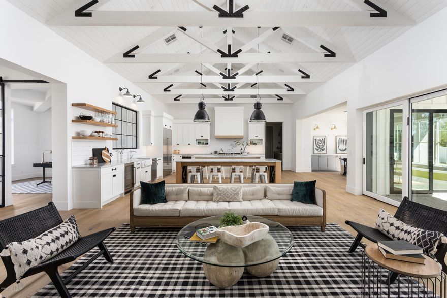 This modern farmhouse in Arcadia-proper is priced to sell. Seller recently included an additional 25 trees to landscaping. With this home sitting on over 1/2 acre and completely unobstructed views of Camelback Mountain it is one of the best priced home of its size, finished detail and location. Every space throughout the home was thoughtfully appointed w/ custom trim & cabinetry. The open floor-plan utilizes every square inch of usable space & caters to modern day living & lifestyles. Chef's Kitchen includes 2 oversized islands, 2 sinks, 2 dishwashers, Wolf & Subzero appliance package & custom hood & cabinetry by Burdette. Bold finishes and hardware bring everything together to give the home a one-of-a-kind look you will appreciate for years to come. The Master Suite's spacious design.... ....provides a private retreat, spa like bathroom, & ample storage & closet space. Each bedroom is appointed w/ its own unique bathroom and a walk-in closet that provides enough room for everyone. Plenty of yard space for enjoyment, whether you decide to take a quick evening dip in the pool/ spa after a long day, or relax by the fireplace watching the sun setting on Camelback Mountain.
