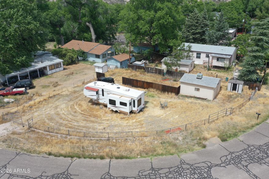 Owner will carry on this .2 Acre parcel, that allows for site built or manufactured homes.  This spacious corner lot, already has a water meter installed. There is a permit in place to install a septic. Fully fenced property includes a storage/workshop perfect for storing your tools while building your home. All of this just moments to Clear Creek. Great soil in the area to plant fruit trees, grape vines and grow a garden. Just moments from hwy 260 for quick access to town. The seller will carry with just 20% down.