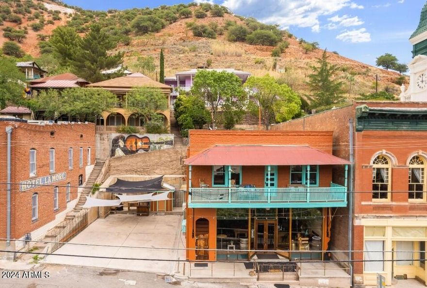 Truly Unique Old Bisbee Property- 3 Bedroom/5 Bath, 3,712 sq ft (including heated/cooled finished basement) with dedicated 2,000 sq ft PARKING LOT. Formerly Copper City Saloon and Hot Licks Saloon, now zoned Residential, with fully intact bar, fully furnished (complete with pool table), retrofitted to serve as a residential kitchen. Finished Basement serves as a Primary Bedroom with Jacuzzi, and 2 additional bathrooms, and separate Laundry Room.
Second Floor currently rented as Airbnb- with two separate units, vast Great Room with full Kitchen, 14' ceilings, hardwood floors, Covered Deck with great views of Downtown Old Bisbee and surrounding hillsides.
Includes 2 Parcels: 103-62-312 and 103-62-313.