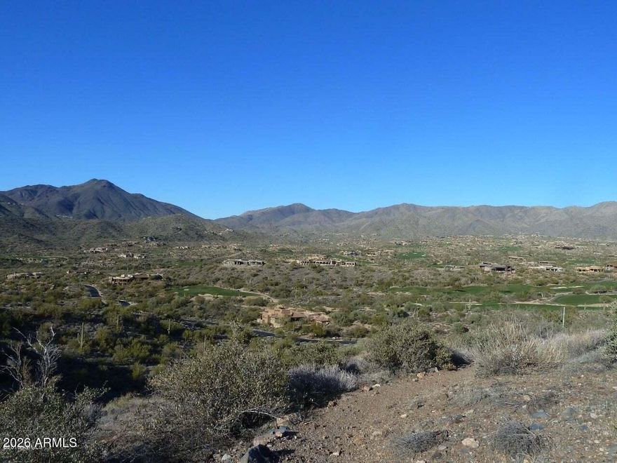 Nestled within one of North Scottsdale's premier communities, this elevated 6.2-acre golf and mountain view lot is located in the exclusive Village of Lone Mountain One at Desert Mountain. Here, the minimum lot size is five acres, ensuring privacy and a sense of open space that is truly rare. The generous 28,989-square-foot building envelope offers endless possibilities for creating a custom estate tailored to your vision, whether you desire a sprawling contemporary residence or a classic desert retreat.
From this prime location, soak in dramatic birds-eye vistas stretching from the iconic silhouette of Continental Mountain to the distant ridge line of Apache Peak. The property boasts coveted multiple tee-to-green views of several holes across three of Desert Mountain's renowned Jack Nicklaus Signature golf courses, providing a picturesque backdrop and a golfer's paradise. As evening falls, enjoy the twinkle of Desert Mountain's night lights and watch as the northern mountains come alive with the brilliant hues of both sunrise and sunset.
Conveniently positioned near the main entrance, the lot also allows for quick access via the Carefree Ranch gate, streamlining your route to Pima Road and Cave Creek Road for easy connectivity to shopping, dining, and all that North Scottsdale and Cave Creek offer. This home site presents a rare opportunity to secure a legacy property in a highly sought-after enclave, blending natural beauty, security, and world-class amenities.
