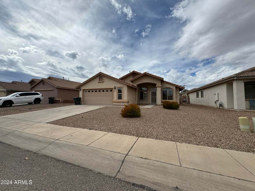 TESLA CHARGER. This beautiful 4 Bedroom, 2 Bath home with a 2 car garage in Sierra Vista, AZ is minutes from Ft. Huachuca, schools, shopping and Canyon Vista Medical Center. Great location, Tesla Charger, solar, dual pane windows, ceiling fans, carpet & tile flooring! The kitchen features an open floor plan. The master features a walk-in closet, and dual sinks! The property is also fully fenced.