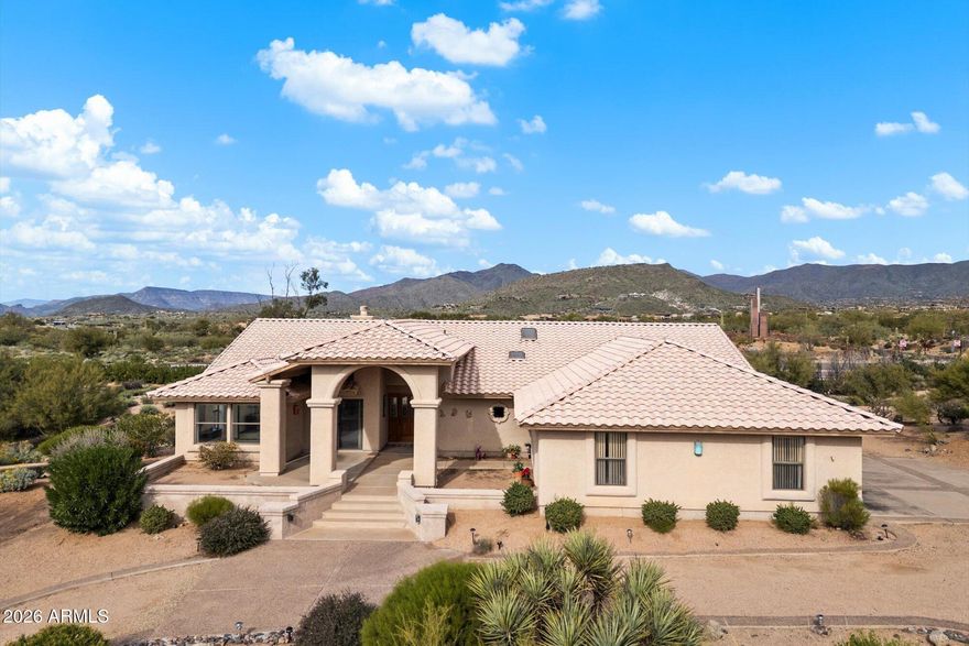 This custom home sits on an elevated one-acre+ lot (el 2,712) capturing sweeping mountain views from the moment you step inside. Located in an upscale neighborhood surrounded by million-dollar homes, the setting offers privacy and room to add value--including plenty of space for a pool or guest house. 
The spacious living room welcomes you with high ceilings, a corner fireplace, and large windows that frame the natural beauty of the desert and mountains beyond. The adjoining dining area flows into the generous kitchen and breakfast nook, all sharing those wonderful views. The kitchen features abundant cabinetry, a breakfast bar, and natural light enhanced by overhead skylights. A warm and inviting den with a wet bar opens to the expansive front patio--an ideal spot to unwind, entertain, and take in the breathtaking sunsets Carefree is known for.  
The split primary suite is exceptionally large, offering peaceful mountain vistas, custom walk-in closet,  a walk-in shower, jetted tub, and a private toilet room.  Two additional bedrooms also enjoy beautiful views and share a spacious second bathroom with a walk-in shower, soaking tub, and private toilet room. A separate guest half bath is conveniently located off the main living areas.
Outside, a circular driveway and an oversized 928 sq ft  3-4 car garage offers ample room for a boat, workshop space, or recreational toys\ reflecting the timeless Arizona lifestyle of space, freedom, and comfort.  An additional 682 sq ft of covered patio and porches gives plenty of outdoor space to sit back and relax. 
This home blends traditional charm with generous living spaces in a setting that truly celebrates the surrounding desert and mountain landscape. All just minutes from the charming towns of Carefree and Cave Creek, known for their Western spirit, wonderful restaurants, art galleries, and boutique shops. Outstanding golfing, hiking, and mountain biking trails are close by. Enjoy darker skies, cleaner air, and nearby lakes Bartlett and Horseshoe as well as the Verde River for outdoor adventures. Situated within the excellent CCUSD school district with convenient shopping nearby.
This house has an approved and certified septic system and has Carefree water (which is very well run and not too expensive).  Annual HOA fees are only $60 adding further peace of mind. 
Come experience the beauty, peace, and promise of living in Carefree.