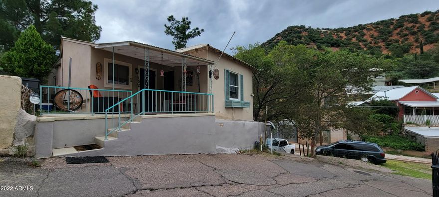 This property has many rare features for Old Bisbee. This sale includes APN's 103-62-247C & 103-62-249D. The lot info includes both pieces. There is room to park at least 6 vehicles on this property! There are 2 spaces on the upper level and at least 4 by the shed below. This cute home features newer Anderson dual pane windows, laminate and ceramic tile flooring and newer appliances. The kitchen is very light and looks out to the park and mountain. The formal dining room as been used previously as a 2nd bedroom. The laundry includes a newer stack washer and dryer. Do not miss this rare opportunity. Call me today for your private showing.