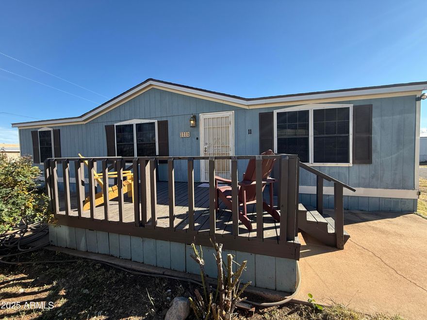 House sits on a corner lot with rose bushes in front, 3 bedrooms and 2 full baths, deck in front for enjoying mountains and sunsets. Washer and dryer stay with home, most rooms have a ceiling fan, there are mini blinds and rolling shades in windows. Primary bathroom has a soaking tub, security door on front and back doors, floors are engineered wood and carpet. Located in a small manufactured home park that is quiet and quant.