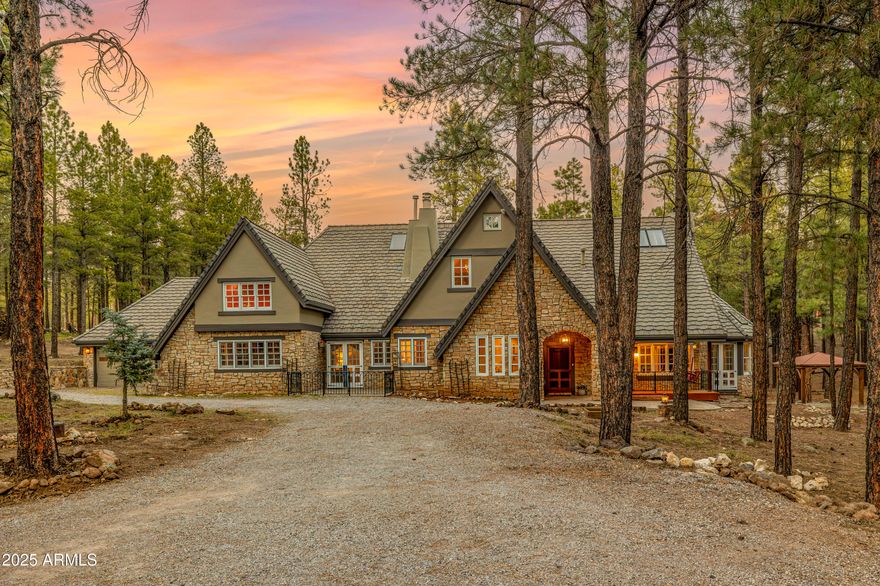 Peaceful, elegant, and full of enchanting character, this luxurious hand-crafted English Tudor—originally designed by its architect as a true Cotswold Cottage on a manor scale— welcomes you with exquisite craftsmanship and architectural detailing at every turn. Perfectly nestled on 5.5 wooded acres backing directly to National Forest land and the Arizona Trail, this extraordinary Flagstaff estate offers a rare blend of privacy, outdoor adventure, and timeless Old-World charm—all just 10 minutes from downtown Flagstaff and the AZ Snowbowl.
Recently expanded to over 5,100 square feet, the home now features five bedrooms and three and a half baths, including a newly added upstairs bedroom and a beautifully designed additional bathroom on the main level. During the expansion, the owners thoughtfully upgraded key areas: the gourmet chef's kitchen received stunning granite countertops, and the primary bathroom was completely transformed with a classic clawfoot soaking tub, elegant fixtures, and a luxurious standalone steam shower, creating a spa-quality private retreat.
Designed as the ultimate mountain and ski getaway, the home also includes an indoor dry saunaperfect after long days on the slopesand an outdoor hot tub set on expanded front and rear patios, each offering tranquil views of the surrounding pines. These spaces make the property ideal for year-round relaxation, entertaining, and enjoying Flagstaff's four-season lifestyle.

For the past several years, the estate has also operated successfully as a distinctive, high-end Airbnb rental. Its warm, whimsical Harry Potter-inspired décor blends effortlessly with the home's authentic Tudor architecture and enchanting storybook setting, creating an unforgettable guest experience and strong rental appeal.

Inside, the chef's kitchen showcases premium Viking appliances and generous workspace, while the grand living room impresses with exposed beam ceilings and dramatic architectural lines. An inviting sunroom offers year-round natural light and peaceful forest views.

The main-level primary suite includes serene woodland vistas and direct access to a private library/officeyour personal haven for reading, work, or quiet reflection. Additional flexible spaces include another first-floor bedroom/office and multiple bedrooms upstairs, offering ideal accommodations for guests, family, or multi-generational living.

Outdoors, enjoy both front and back covered porches, the expansive patios, and frequent visits from local deer and elk. Horse enthusiasts will appreciate the three-stall Barnmaster barn with a tack room and secure corral, blending convenience with refined country elegance.

This remarkable estate is rich with handcrafted details, architectural pedigree, thoughtful modern upgrades, and ski-retreat amenitiesfar more than a single description can capture. Please view the virtual tour, high-resolution photos, and detailed property information sheet to fully experience the magic of this extraordinary Flagstaff retreat.
Prepare to be enchanted.

*No third-party vendors authorized without listing agent approval.