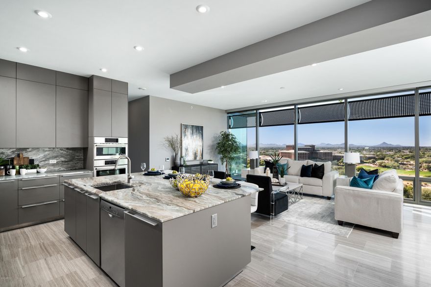 An opportunity like no other available at the Optima at Kierland. Ideal for the family that wants condominium living but also adequate and ideal space to live, have privacy and entertain. This 4116 square foot, barely lived in condominium boasts extraordinary views of golf, sunsets, lights and mountains - a view that can't get any better. Combine that with 4 bedrooms (current media room can be 4th bedroom), 3 1/2 baths, office, unbelievable storage and beautifully finished closets and you have a floorplan to satisfy most anyone. An extra bonus are the 3 assigned parking spaces and  electric vehicle charger - it's perfect. Check out additional remarks for Optima amenities available in this desirable and sought after community. The Optima has amenities to support this lifestyle choice with rooftop pool and cabanas, extraordinary fitness room, basketball and squash courts, golf simulator and putting green, multiple outdoor gathering spaces, meeting rooms and more. Photos don't tell the story, it's something that must be seen to be believed. Floorplan in documents tab.