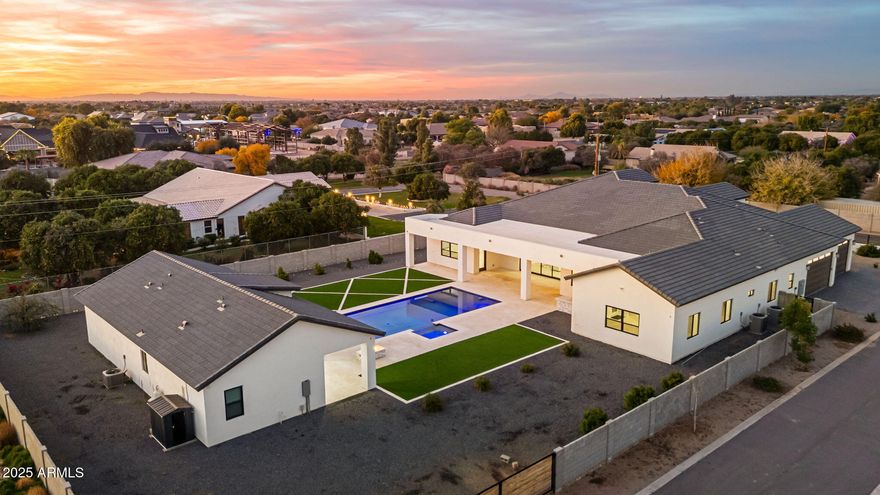 An exceptional offering in the heart of Gilbert, this privately gated luxury estate is the definition of refined desert living. Set on a pristine one-acre lot with unobstructed mountain views, the residence seamlessly blends architectural elegance, modern sophistication, and resort-style comfort.

The nearly 5,900-square-foot main home showcases impeccable craftsmanship throughout, anchored by a chef's kitchen outfitted with Thermador appliances, a Sub-Zero refrigerator, quartzite countertops, and a discreet butler's kitchen ideal for elevated entertaining. The spa-inspired primary suite is a true retreat, featuring a soaking tub, a marble-appointed walk-in closet, and a rare in-suite washer and dryer for ultimate convenience.

Designed for both everyday luxury and grand gatherings, the home offers a spacious game room, a refined executive office, and a thoughtfully designed laundry room complete with a custom dog-wash station. A detached 1,200-square-foot guest residence provides exceptional flexibility, featuring two bedrooms, a full kitchen, and a private living areaperfect for extended family, guests, or multi-generational living.

Outdoors, the estate transforms into a private resort. An oversized pool and heated spa are complemented by a firepit and expansive grounds with ample space for a future RV garage, sport court, or custom amenities. The four-car garage is EV-ready, and smart-home technology is integrated throughout, ensuring modern convenience without compromise.

Located just minutes from top-rated schools, Seville Golf & Country Club, and Gilbert Regional Park, this rare estate offers privacy, prestige, and lifestyle in one of the East Valley's most coveted enclaves.

This is not just a homeit is a statement of luxury, space, and timeless design.