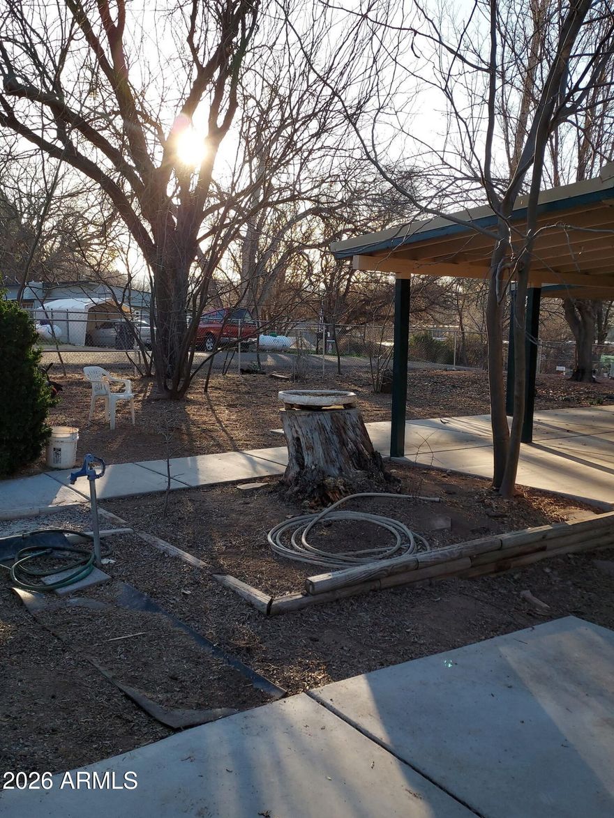 PRICE IMPROVEMENT ON THIS FULLY REMODELED Single-Wide Manufactured Home sits on a large lot and features 3 bedrooms and 2 full baths. The spacious living room has a full flagstone hearth with a wood-burning stove. It includes a dishwasher, a new range hood, a washer and dryer, and furnace. NEW hot water heater. The property has new propane service with a one-year transferable contract with Verde Valley Propane, powering the furnace, dryer, and kitchen stove. There are no HOA fees. The entire property is enclosed with chain-link fencing and gates dividing the front and back yards. All structures have metal roofs. There is a detached two-car garage with a small workshop area, along with two small sheds in the backyard. The septic system was inspected and certified in January 2026. The property has been extensively upgraded, including new skirting and perimeter insulation, new access doors, fresh exterior paint, new beams and leveling under the structure. The interior features new flooring, trim, and paint throughout. The bathrooms have new toilets, sinks, and vanities. All lighting and hardware are new. A fully enclosed back porch has new carpeting, while the front enclosed porch has a fresh concrete paint finish matching the back carpeting. Enjoy a relaxed lifestyle in Camp Verde!