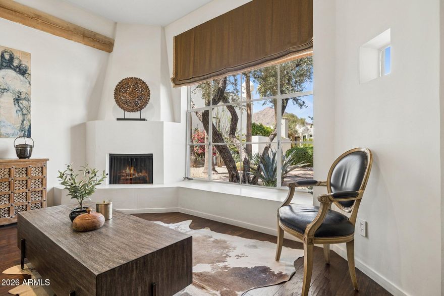 A truly special move-in-ready turnkey property in the iconic Casa Blanca community at the base of Camelback Mountain. This highly coveted & charming light-filled single-level residence offers mountain views, timeless design, and effortless 24 hour guard -gated lock-and-leave living. Thoughtfully designed with 10-foot exposed beam ceilings, hickory flooring, a gas fireplace, European cabinetry, Viking gas range, Sub-Zero refrigerator & strategically placed skylights. An expansive
-- 400 s.f. east-facing patio creates exceptional indoor/outdoor living space just steps from the main pool and renowned rose garden. Set within 22 acres of lush resort-style grounds, Casa Blanca features 3 heated pools and spas, tennis and pickleball courts, meandering walking paths, and 24-hour guard-gated security. The flexible second bedroom is ideal as a guest room or home office. Located minutes from hiking, golf, Scottsdale Fashion Square dining, and Old Town Scottsdale.