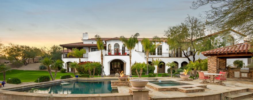Magnificent Paradise Valley Estate with spectacular 280 degree views of Camelback Mountain, Praying Monk, Phoenix Mountain Preserve & City Lights. Pass through the courtyard gates an& enter a world of serenity. This one of a kind retreat is 9188 sf and sits on over an acre with 5 bedrooms, 7.5 bath. It has gorgeous built-ins in the executive size office, a Formal Living room & a casually elegant Dining Room. The Gourmet kitchen features granite counters, huge entertaining island, Dacor & Sub Zero appliances & a large eat in breakfast nook which opens to cozy great room. Oversized walk in wine cellar & amazing butler's pantry separate the kitchen & dining spaces. Spacious master retreat with beamed ceilings, canterra stone fireplace & his & her closets and baths. Features include a home theatre, billiard room, media & an attached guest suite. Perfect for families and entertaining this home boasts a lush green resort like backyard with a pool, spa, numerous patios, ramada and outdoor kitchen. This uniquely situated residence is adjacent to some of Phoenix's most treasured restaurants, resorts, shopping & great schools! Too many features to list, you must see this home to fully appreciate.