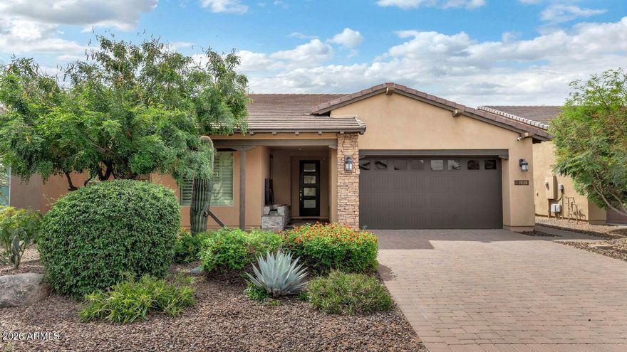 Luxury meets low-maintenance living in Trilogy at Verde River! This stunning single-level residence showcases exceptional curb appeal with a paver driveway, stacked-stone exterior accents, and a warm private courtyard entry. Inside, the sought-after Great Room design is elevated with designer finishes, wood-look tile flooring, plantation shutters, custom accent walls, and seamless indoor/outdoor living through expansive sliding glass doors. The showpiece temperature-controlled glass wine display with LED lighting creates an unforgettable focal point, while the gourmet kitchen features quartz countertops, stainless steel appliances, upgraded cabinetry, decorative backsplash, and under-cabinet lighting. The spacious primary retreat offers a spa-inspired bath with dual vanities and oversized walk-in shower, while guest spaces are equally refined and inviting. Step outside to your private resort-style backyard complete with covered patio, built-in BBQ island, fire feature, manicured landscaping, and stylish entertaining spaces designed for Arizona evenings. Enjoy world-class amenities including pools, fitness center, pickleball, tennis, bocce, dining, spa services, social events, and miles of hiking/biking trails. Optional golf membership provides access to the Tom Lehman-inspired championship course. Minutes from Scottsdale, yet surrounded by Sonoran Desert beauty.