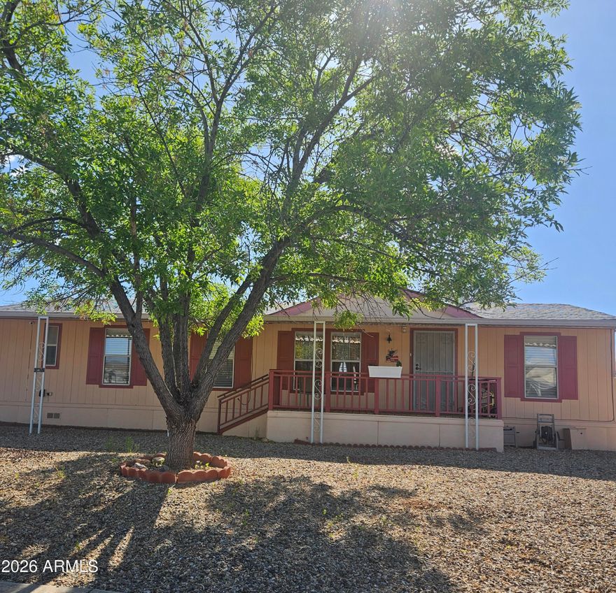Big & Beautiful! Well maintained. 3 Bedroom, 2 bath split floor plan. Open floor plan. Great room with formal dining and breakfast nook. Mountain views on a large lot with easy care Xeriscape type landscaping. 2 Car carport. Large, comfortable front and rear covered patios. Two ramps on back patio. Fenced backyard. Terrace area for your garden! Roof and Mini Split are new in the last few years. Laminate flooring new in the last year. Close to the center of town. Desirable Gated Community offers an indoor pool, an outside pool, spa, 2 clubhouses, play ground, pickleball, dog park to name a few amenities! Lot rent includes water, sewer and trash.