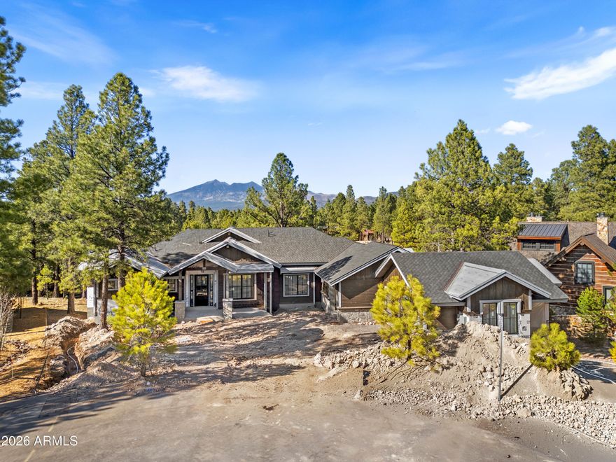 Discover unparalleled refinement and charm in this breathtaking new construction nestled in the heart of Pine Canyon. Tucked at the end of a quiet cul de sac with stunning peak views, this gorgeous mountain retreat features two split-floorplan primary suites on the main level, a sprawling living space with huge compound slider leading to the massive back deck, high end Pella Impervia windows and doors, and so much more! Soaring ceilings create an airy open feel living room, while a sleek linear fireplace anchors the room as a warm and inviting centerpiece. Breathe in the crisp pine air from either the upper deck or lower patio, each appointed with cozy outdoor wood-burning fireplaces. This is a one-of-a-kind expansive estate, boasting almost 10,000 sq ft under roof and 6,169 livable sq ft.