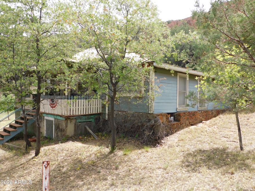 Rare Historic Homestead - First Time Ever on the Market! 7.03 Private Acres in the Heart of the Mule Mountains, Old Bisbee For over a century, this extraordinary property has been cherished by the same pioneering family. Homesteaded in 1910--just two years before Arizona became a state on Valentine's Day 1912--this authentic ranch has never been offered for sale... until now. Tucked into the breathtaking Mule Mountains on the corner of historic Old Divide Road this 7.41-acre mountainside sanctuary delivers 360-degree jaw-dropping beauty. Mature forest surrounds you as the land climbs the Bisbee Divide toward Morales Creek. Panoramic views unfold in every direction--dramatic cliffs, endless skies, and the timeless spirit of old Bisbee.The main historic.. .. .ranch home offers approximately 1,271 sq ft of comfortable living space, anchored by a remarkably large basement with cement floors and walls, windows for natural light, and convenient outside or second-floor entrances--literally built into the side of the mountain. Still a short walk or quick drive into everything Old Bisbee has to offer, including award-winning restaurants, artist studios and exceptional bands and entertainment daily.
Beyond the home, the property includes a treasure trove of original structures from Bisbee's vibrant mining era: an old kitchen and food prep/dinner hall (once serving miners' cabins), a garage, and two additional buildings ripe for creative revival--think workshops, storage, or charming guesthouses with a little TLC. Flat areas throughout provide plenty of room to build, dream, or expand. This is a true off-grid-capable retreat with a private domestic well (currently partially set up for solar, with two water tanks positioned for gravity feed). Electric and water are available on adjoining lots, and roughly half a lot sits within city limits--offering intriguing potential for annexation and access to city services (buyer to research and confirm all utilities). Five and a half of the six separate tax codes keep taxes remarkably low, with the balance in the county. The land tells rich stories: it once hosted a vintage gas station straight out of a 1940s-50s movie, and it was fully remediated by Freeport-McMoran, ensuring a clean slate. Located on the county/city line in one of Bisbee's most sought-after mountainous areas, this homestead captures the soul of Arizona's mining heritage while offering modern-day privacy and possibility. Whether you envision a peaceful full-time mountain escape, a family legacy property, an artist's or homesteader's paradise, or a unique investment/hotel/ Inn built in living history--this is a once-in-a-lifetime opportunity. Sold strictly AS IS, with no guarantees or warranties, allowing you the freedom to restore, reimagine, and make it your own. PROUDLY own bragging rights to a genuine piece of Arizona history with endless stories, memories & same gorgeous century-old views with endless potential, and endless inspiration. Properties like this simply do not come along every day. Step into a legacy carved from the mountains themselves.

SIX tax codes total acreage is 7.03 Acres:

103-60-209G is 0.04 Acres
103-60-304G is 2.14 Acres
103-60-305G is 2.03 Acres
103-60-310G is 2.30 Acres
103-60-311F is 0.45 Acres
103-60-311G is 0.45 Acres