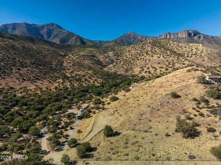 Once in a lifetime place to build your dream home or invest in a truly unique property? This is exactly what you've been waiting for. Nestled in a peaceful and picturesque setting, the land offers not only natural beauty but also the practical features you need to make your vision a reality. Imagine two wells on the property: one capped and uncased, and the other solar-powered, feeding a 1,500-gallon underground holding tank with a brand-new pump and tank. The septic system is also newly installed, featuring a 1,000-gallon tank and a fully permitted mound system. It's all set up and ready to support your future home. The property is fully equipped with a solar system that provides power for the existing RV site on the lower portion of the land. With 10kW of battery