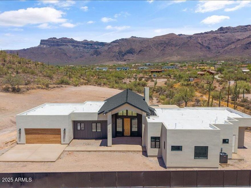 Where Desert Meets Distinction  - Welcome to Kings Ranch Ct. Set against the awe-inspiring backdrop of the Superstition Mountains, Kings Court Ranch is where timeless craftsmanship and desert elegance come together. At the heart of the home, the stunning gourmet kitchen is designed to impress with double islands, premium appliances, and ample space to gather making entertaining effortless. The centerpiece of the living area is a striking fireplace, blending modern design with rustic warmth to perfectly reflect the surrounding desert landscape. The home features 2x6 construction, 5/8'' drywall, and advanced foam insulation for enhanced soundproofing and energy efficiency. A robust 400 Amp electrical service and 20 Amp outlets at every location ensure your home is built for modern living at Kings Court Ranch, every detail is designed to elevate your lifestyle - where desert beauty meets custom luxury, and the Superstitions are your everyday view.