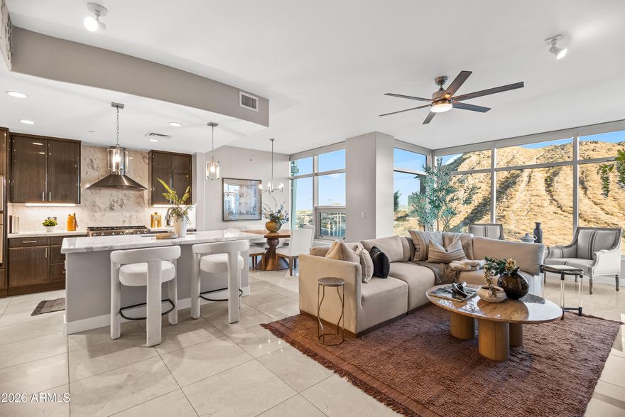 and entertaining, the open-concept floorplan features angled architectural windows that create a striking visual effect while maximizing natural light and views. The spacious kitchen is appointed with high-end appliances, granite countertops, and seamless flow into the living and dining areas. Step outside to the oversized private balcony, the perfect place to enjoy incredible Arizona sunsets and city lights.
Both bedrooms offer floor-to-ceiling windows and impressive views. Additional features include 2 premium parking spaces conveniently located near the elevators and a private locked storage area.
Bridgeview offers resort-style amenities including multiple outdoor lounge areas, pool & spa, fitness center, community room, and on-site luxury tower conveniences. Ideally located near ASU, Mill Avenue, Tempe Beach Park, light rail, Sky Harbor Airport, dining, shopping, entertainment, and freeway access. Ideal as a full-time residence or lock-and-leave lifestyle opportunity.