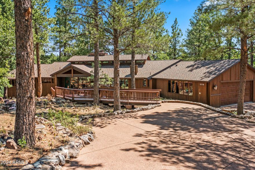 This architecturally significant post-and-beam home, crafted by the renowned Deck House/Acorn Deck House Company, embodies the mid-century mountain modern aesthetic. Showcasing beautiful teak and mahogany wood accents throughout, the residence offers floor-to-ceiling glass walls that fill every space with an abundance of natural light. With its thoughtful design, this home delivers an enchanting Ponderosa pine ''treehouse'' feel, perched above the #9 green of the Canyon Course and spanning just under an acre in a serene cul-de-sac.
Inside, a striking tongue-and-groove wood ceiling crowns the open great room, providing an inviting and expansive setting. A dedicated game room, complete with a wet bar, accompanies three fireplaces and two laundry rooms for added convenience. This home boasts a new roof installed in 2016, alongside substantial interior updates completed between 2018 and 2019, including a fully refreshed kitchen, upgraded lighting fixtures throughout, updated bathrooms, newly painted interiors, and HVAC units with added air conditioning.
The property also features a reverse osmosis water system in the kitchen, an EV charger in the garage, and multiple outdoor decks for relaxing and entertaining. For an extra touch of adventure, a treehouse hideaway for kids awaits, making this home a truly special retreat.
Tucked away amidst 1,100 acres of pristine alpine beauty, Forest Highlands exudes an unparalleled sense of exclusivity and serenity. With two championship golf courses designed by Tom Weiskopf and Jay Morrish, Forest Highlands sets the stage for unforgettable golf experiences. The community offers an array of exceptional amenities, including two clubhouses, multiple dining options, tennis courts, swimming pools, and miles of hiking and biking trails. Forest Highlands is a retreat where luxury meets nature, ensuring a harmonious lifestyle for its residents.
