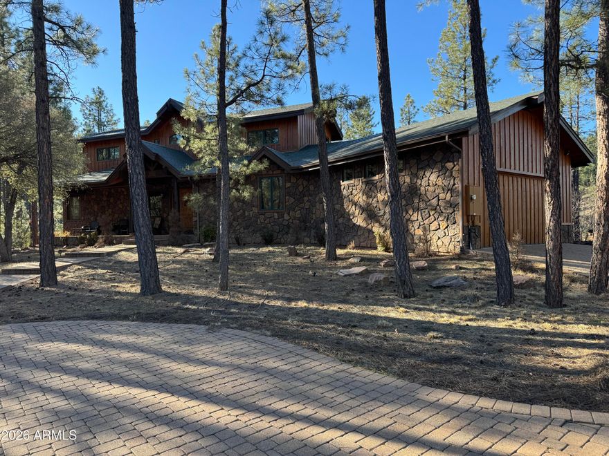 Beautiful custom cabin in Hunter Creek Ranch overlooking the forest with no homes behind. This 4 bed, 3 bath retreat offers ~3,000 sq ft with a dramatic 2-story family room and large windows showcasing serene wooded views. Features include granite counters, custom cabinetry, travertine tile, and multiple fireplaces (2 wood, 1 gas). Spacious primary suite with fireplace and jetted tub. Enjoy the outdoors from the two-story covered patio with pavers overlooking the forest. A private, upscale mountain escape.

The .53 acre lot next door is also for sale at $100,000 if purchased with the cabin.