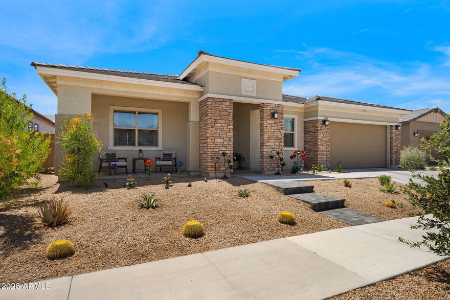 Welcome to your dream home! Built in 2023, this stunning property looks like a model home and offers a highly desirable split floor plan.  The heart of the home is an open, airy great room with 12' of sliding glass doors (w/solar tint)and custom entertainment center with a granite countertop.  Chef's platinum kitchen is a true showpiece, highlighted by a large granite island, pendant lighting, stainless steel appliances, a Monogram 48'' 6-burner commercial grade gas stove with professional hood and double oven, wine refrigerator, convection microwave, and a generous walk-in pantry.  The 10' ceilings provide an extra sense of openness, making the entire home feel spacious and light-filled.  Wood-like plank tile flooring throughout adds... a warm, natural charm (no carpet).The luxurious primary suite includes an oversized walk-in shower, double vanity, and two walk-in closets with custom built-ins. The versatile den off the foyer is ideal for families who need a home office or playroom. A private guest suite with its own bathroom is also situated at the front of the home.   Plenty of storage - 3 bedrooms with generous walk in closets. Additional upgrades include a storage shed and water softener.  Energy efficient home with 3 temp zones and foam insulation (avg electric bill $150/month)...will save you tons of money. Step outside and you'll find a beautiful, low maintenance backyard that features a 16x20 pergola covered patio with a greenhouse roof with misters, lights and speakers - perfect for entertaining friends and family. Huge 3.5 car garage with additional storage space, added large panel LED lights, epoxy garage floor and Ring security camera with floodlight.  Located in the thriving and growing community of Laveen, this property is perfectly situated with convenient access to 202, restaurants, shopping, parks and schools. The neighborhood of Dobbins Village offers a strong sense of community with frequent food truck and neighbor events. This home offers so much more than just four walls--it's a lifestyle, a retreat, and a place to create lasting memories.  Don't miss this opportunity!!
