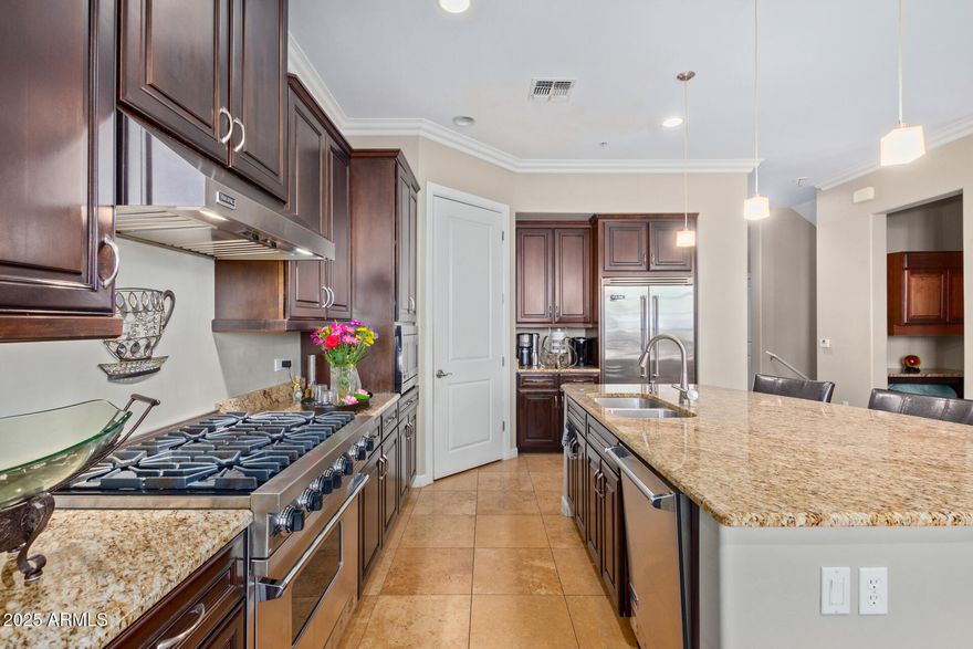 Rare live-work condo with stunning Camelback Mountain views. This unique unit offers the legal ability to operate a commercial business and an ideal office location just off Scottsdale Road. The elevator-equipped residence features Viking appliances, granite countertops, and travertine and wood flooring. Enjoy breathtaking sunsets from four private patios and multiple balconies. Community amenities include a heated pool, jacuzzi, ramadas, barbecues, and a beautifully maintained 10-acre park for residents to enjoy. A Tesla charger is included in the two-car garage. Conveniently located near premier shopping and dining, yet away from Old Town crowds--an exceptional opportunity to live and work in the heart of Scottsdale. Update - NEW INTERIOR PAINT 3/22/26.