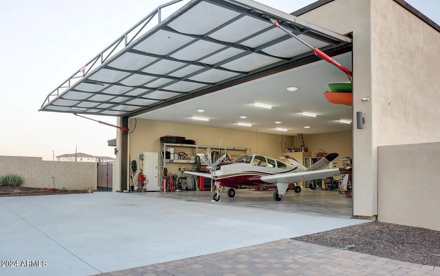 Welcome to your dream oasis! This stunning 3-bedroom, 2.5-bathroom home, nestled in Arizona's highly desired aviation neighborhood, Pegasus airpark, offers a perfect blend of luxury and functionality. Inside the 52' x 52' hangar you can park your aircraft with space to fit all of your toys! Step inside the home to be captivated by the meticulous attention to detail and premium features that define this residence, including an office with views of the San Tan mountains, a theatre room, a gourmet kitchen and a resort style owners suite with a private workout room, Outside into your private oasis - the backyard is an entertainer's paradise. Enjoy a game of pickleball on your private court, relax in the above-ground spa, or cool off in the pool. You won't want to miss this incredible home!