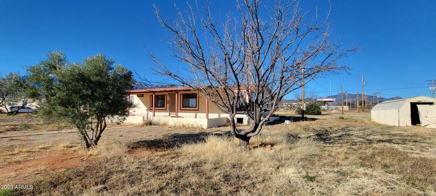 This is a very special property! There is a detached oversized 2 car garage, another detached shop that may fit 4 vehicles, owned solar and a fenced corner lot that you may have horses on! The home has 3 bedrooms and all have their own walk in closet. There is an open floor plan and there is a real fireplace in the area off of the kitchen. The master suite is split from the secondary bedrooms and has a garden tub plus a separate shower. There is a large covered patio in front and a handicap ramp in the back. The seller is unable to make any repairs on this property so the home is priced accordingly.
