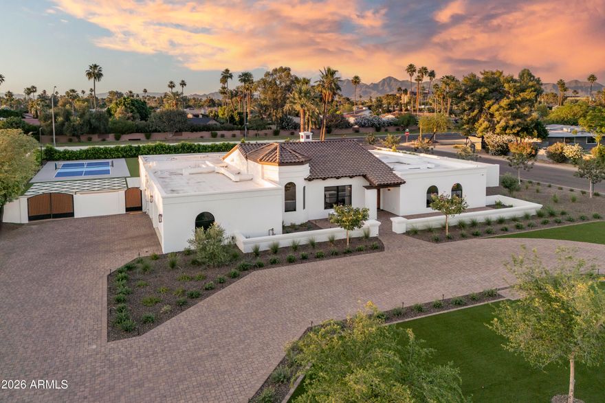 In Indian Bend Ranchos, where land has become one of the last true luxuries, this 38,089 sq ft corner property with only one direct neighbor, stands apart for a simple reason, there is nothing compromised about it. Set within a private collection of custom homes, with no HOA, it offers a kind of freedom that's increasingly rare. 
Every SQFT has been thoughtfully utilized and REBUILT IN 2025 , while still offering the opportunity to expand and create additional value. A warm Santa Barbara sensibility runs throughout, expansive in scale, balanced in proportion, and restrained in tone. Vaulted wood-beamed ceilings give the interiors height and presence, while a quiet palette allows the materials and light to speak for themselves. This estate has been reworked in its entirety, with a level of finish that remains consistent from one space to the next. At the center, the kitchen is substantial, with custom cabinetry, stonework, and a walk-in pantry, opening seamlessly to the main living areas and beyond. The layout is resolved with clarity, including a split primary suite that offers privacy without disconnect.
Outdoors, the property reveals its full advantage. A custom NanaWall system allows the main living spaces to extend directly to the terrace. A covered outdoor living area with a full kitchen anchors the rear of the home, while a private pool and separate pool house introduce flexibility, equally suited for guests or a more personal retreat. Beyond, a fully lighted pickleball court and an uninterrupted stretch of manicured turf create something rarely found at this level: space that is both generous and entirely usable.
A composed arrival, structured landscaping, and a three-car garage with the ability to expand complete the experience. It simply gets it right.