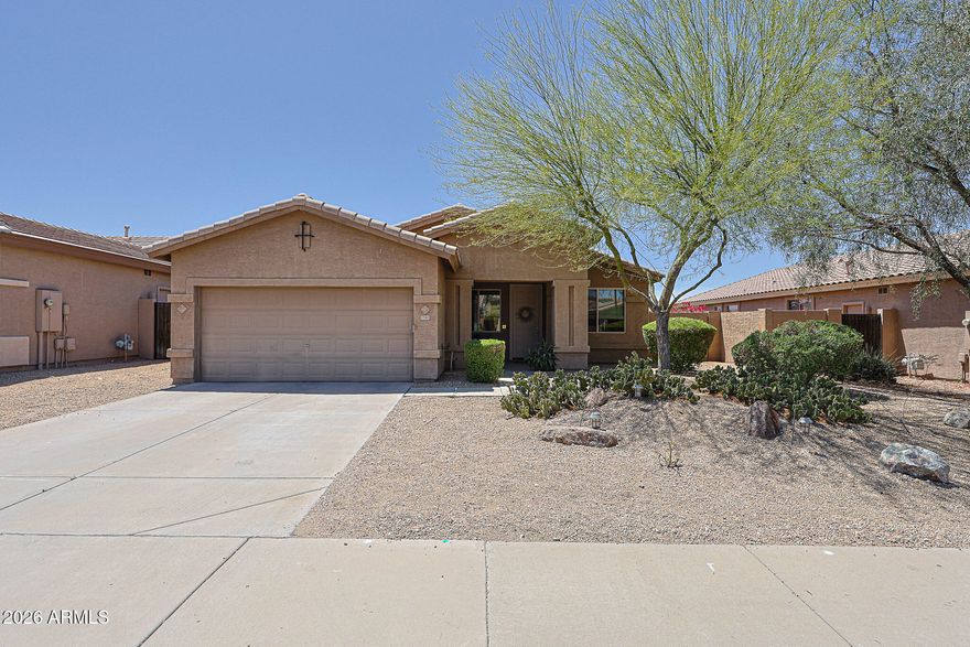 Welcome to a home that truly blends thoughtful design, everyday comfort, and effortless Arizona living. This beautifully upgraded 4-bedroom, 2-bath residence with a dedicated office/bonus room offers a flexible layout perfect for working from home, creative pursuits, or simply spreading out and enjoying your space. From the moment you step inside, you'll notice the light-filled interior enhanced by solar tubes, upgraded windows, and consistent luxury vinyl and tile flooring throughout - no carpet, just clean, modern living.

At the heart of the home is a spacious, beautifully appointed kitchen designed for both functionality and connection. Featuring granite countertops, high-quality cabinetry, stainless steel appliances, a large walk-in pantry, and stylish pendant lighting, it flows into the family room. Here, there is custom built-in cabinetry and a large picture window create a warm, inviting space ideal for gathering, relaxing, or entertaining, with easy access to both the backyard and side yard.

The primary suite is a peaceful retreat, offering generous space, abundant natural light, and direct access to the backyard - perfect for enjoying quiet mornings or winding down in the evening. The ensuite bath features dual sinks, an oversized, fully tiled walk-in shower, and a spacious closet designed to keep everything organized.

Secondary bedrooms are anything but ordinary - each thoughtfully designed with custom built-in beds, including a loft-style option, maximizing floor space while adding charm and functionality. The additional office/bonus room with built-in desks and storage makes working from home or tackling hobbies both convenient and inspiring.

Step outside to your own private backyard oasis, where an extended pergola, built-in BBQ, artificial turf, and low-maintenance desert landscaping create the perfect setting for entertaining or simply enjoying Arizona's beautiful weather year-round. The oversized lot provides added privacy and room to relax.

Beyond its beauty, this home shines in efficiency, with features like a radiant barrier, custom attic fan, and upgraded insulation, keeping utility costs low, with average electric bills around just $165/month for full-time living. The attic also provides comfortable, usable storage space - an uncommon and valuable bonus. Plus, the garage is climate-controlled by the mini-split HVAC system. 

Located in the award-winning Master Planned Community of Estrella, you'll enjoy a lifestyle that goes far beyond your front door. Residents have access to resort-style amenities including lakes, walking and biking trails, community pools, fitness centers, golf, dining, and year-round events. Surrounded by scenic desert landscapes and mountain views, Estrella offers a perfect balance of outdoor adventure and everyday convenience - making this not just a home, but a lifestyle.
