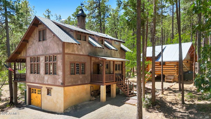 Hidden among towering pines bordering Prescott National Forest, this gated mountain retreat offers privacy, craftsmanship, and peaceful living just 20 minutes from Costco, shopping, and dining in Prescott. Set on fully fenced acreage with potential to split the lot, this unique property is ideal for a second-home getaway, creative retreat, or anyone seeking quiet seclusion in the forest.
The 1,440 sq ft main home features 2 bedrooms and 2 bathrooms with soaring wood ceilings, handcrafted windows and doors, rich custom cabinetry, and rustic elegance throughout. Built by craftsmen with attention to detail, the home blends warmth and character with comfort and functionality. Covered decks overlook the pines and create the perfect setting for relaxing, entertaining, or simply enjoying the the serenity of nature.

Adding to the property's charm is a detached 216 sq ft hand-hewn log guest cabin studio complete with a full bath and kitchenette--perfect for guests, extended stays, a private office, or creative space.
Located beyond the city on a dirt road surrounded by forest and wildlife, this is a rare opportunity to own a truly special mountain property designed for those who value peace, privacy, and authentic craftsmanship.