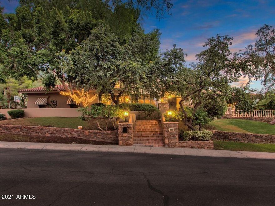 NESTLED BEHIND A GATED COMMUNITY AND LOFTED ON CAMELBACK MOUNTAIN, LIES THIS EXQUISITELY DESIGNED MASTERPIECE. ENTER THROUGH THE METICULOUS FRONT ENTRANCE, TO THE GRAND, TWO-STORY FOYER. TO YOUR LEFT LIES ONE OF THE MANY DINING AREAS. THIS FORMAL DINING ROOM SHOWCASES AN EXTRAVAGANT CHANDELIER AND BAY WINDOWS WITH A NOOK FOR ADDITIONAL SITTING ROOM, SETTING THE BAR FOR LUXURY. TO YOUR RIGHT - AN IMMACULATE LIVING SPACE BOASTS A FIREPLACE, LARGE WINDOWS AND A UNIQUE BEAMED CEILING DESIGN. ALSO, ON THE MAIN LEVEL - AN EN-SUITE WITH PATIO ACCESS, THE PRIMARY LIVING ROOM, A MASSIVE KITCHEN THAT FLOWS INTO THE GREAT ROOM AND TWO OTHER DINING AREAS. FEATURED IN MAGAZINES â€“ THIS GOURMET KITCHEN BOASTS A BEAUTIFULLY DESIGNED VAULTED CEILING, TREMENDOUS ISLAND, BREAKFAST BAR, CONCEALED REFRIGERATOR, WINE COOLER, CUSTOM CABINETRY, GAS COOKTOP, TWO SETS OF DOUBLE OVENS AND THREE SINKS THROUGHOUT FOR CONVENIENCE. A HUGE BUTLER'S PANTRY IS LOCATED JUST BEHIND THE KITCHEN AND LEADS TO A DINING AREA, SERVING AS THE PERFECT PLACE FOR DINING AND ENTERTAINING PREP.  THIS EXTRAORDINARY DINING AREA FEATURES GORGEOUS GLASS DOORS SURROUNDED BY A WALL OF WINDOWS, MAXIMIZING THE NATURAL LIGHT. JUST OFF THE KITCHEN, ANOTHER DINING AREA, THIS ONE SHOWCASING A BEAUTIFUL ALCOVE WITH A VIEW OF THE LUSH BACK YARD AND ACCESS TO ONE OF THE MANY PATIO AREAS, PERFECT FOR ENTERTAINING! TRANSCEND THE CURVED STAIRCASE TO THE UPPER LEVEL WHERE THE MASTER SUITE, TWO ADDITIONAL BEDROOMS AND A LOFT AREA REMAIN. THE INCREDIBLE MASTER SUITE BOASTS SITTING ROOM, A FIREPLACE, PRIVATE VIEWING DECK TO ADMIRE THE SPARKLING CITY LIGHTS, DUAL VANITY, STEAM SHOWER, JETTED TUB, A MASSIVE MASTER CLOSET AND ITS OWN LAUNDRY AREA. MASTER SUITE CONTAINS AN ADJACENT OFFICE/LIBRARY AREA WITH FLOOR TO CEILING BOOKCASES, PRIVATE VIEWING DECK AND DIRECT ACCESS TO THE MAIN FLOOR. A LOFT GAME AREA SEPARATES THE MASTER SUITE FROM THE OTHER TWO UPPER LEVEL BEDROOMS AND HOSTS AN EXCEPTIONAL VIEW OF CAMELBACK MOUNTAIN. THE OUTDOOR LIVING SPACE IS UNMATCHED! ADVENTURE AWAITS AMONGST THE LUSH VEGETATION, LARGE GRASSY AREA, A WATERFALL, SPANISH-TILED RESORT SCALE POOL AND SPA, OUTDOOR FIREPLACE, BUILT-IN BBQ. LARGE KOOL DECK AREA FOR LOUNGING AND SEVERAL COVERED PATIOS. THIS SANTA BARBARA IS SURE TO IMPRESS ANYONE LOOKING FOR THEIR OWN PRIVATE PARADISE!