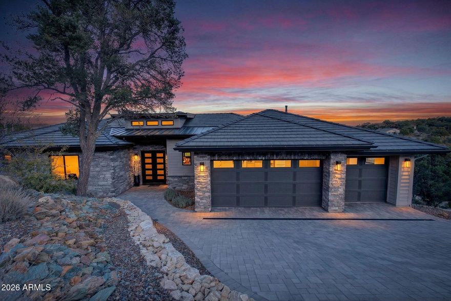 Step inside and take a deep breath -- this is the kind of home that makes you slow down to take it all in! From the double doors to the sweeping deck, every space frames the views: mountains, boulders, trees, and the peaceful sight of Hole #2 at Capital Canyon Club just below. On clear nights the sky goes dark and the Milky Way pops into view -- it feels like your own private retreat, yet downtown Prescott and its energy are just a short drive away.

This house was built elegantly for everyday comfort and for sharing good times. The main level offers a Primary Bedroom plus two more bedrooms with walk-in closets, and a cozy den/bonus living area for main level living. Downstairs, you'll find two more bedrooms with walk-in closets and a family room -- great for all to enjoy. Both levels are brighten by lots of natural light and their own large decks, giving you a place to step outside and enjoy the outdoors at all times. Heating and cooling are zoned for extra comfort.

If you love to cook, this kitchen will make you smile: Wolf dual-fuel range, pot filler, big island that seats four, built-in wine cooler, Bosch dishwasher, disposal and a large walk-in pantry that with enough outlets for all your appliances. Quartzite and quartz counters finish the space beautifully. The primary suite is a calm, spa-like spot with his-and-hers vanities, a soaking tub, and a generous shower. You will love the tiled walls and chandelier over the free standing tub. Thoughtful touches like motion-sensor lights under the floating vanities and custom closet organizers make daily life easier.
Practical things were handled with care: three oversized garage bays with natural light, built-in storage, epoxy flooring and a French drain; a roomy laundry with utility sink and cabinets; two large storage rooms that could be adapted for an elevator. The community is Firewise and the home was built to meet those standards -- HOA inspections keep the neighborhood compliant with the Firewise requirements. Club membership at Capital Canyon Club is optional and the clubhouse is a short distance away.
This home whispers calm, elegance, nature home where you can watch wildlife, host friends on a deck for sunset, and still be close to Prescott's shops and restaurants -- this is the one for you.