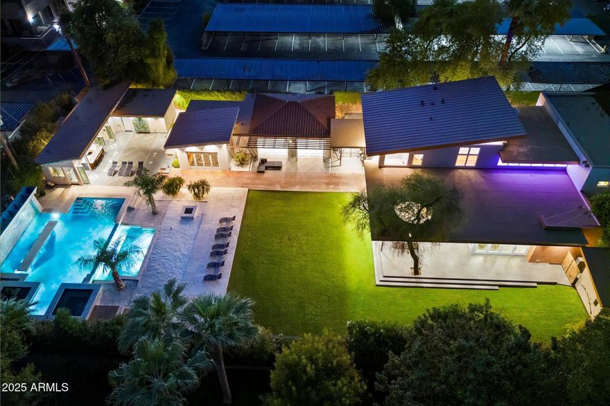 Elegant and Prestigious :: completely rebuilt in 2022 of a 1920 registered historic home. With more than 7,000 sq feet of finished decks, it's a perfect venue for upscale gatherings, grand events, and raising your family. Upon entering through a stunning oversized glass pivot door, you're greeted by a chic glass floor walkway above with state-of-the-art custom accent lighting that leads you through expansive living areas. The heart of the home is a chef's kitchen designed for the most discerning culinary enthusiasts, featuring custom Heston refrigerators, a 17-element stove, and a custom wine refrigerator. Equipped with floor-to-ceiling folding glass doors, providing an indoor/outdoor experience that captivates the modern yet timeless elegance of this magnificent estate. The wine bar, cigar/china room and sleek elevator add a touch of new age convenience to the home's historic character. Hand-selected imported Burmese wood floors lead you to the dining area adorned with crystal chandeliers, all equipped with lift systems for easy cleaning. Guests may enter through the historic entrance greeting them an impressive backlit opal floor and custom spiral glass staircase.

For relaxation, retreat to the master suite, complete with a hot tub on the private patio, a mini kitchen, and a wine room. Each bedroom features its own ensuite bathroom and independent AC zone. The property is also equipped with smart home technology throughout, making it easy to set the perfect ambiance for any event.

Outside, the Malibu-style backyard features a vast pool with a swim-up bar, custom waterfall and tanning bubbler platform, white sand lounge areas, and an outdoor kitchen equipped for any occasion. The pool also features a spa and a cold plunge. A spa building with a steam shower, sauna, and locker room complements the lifestyle, while a gym with sliding glass doors offers an indoor-outdoor fitness experience.

The guest house provides privacy for visitors, with a fully equipped kitchen, custom tile flooring, and sliding glass doors. Every inch of this home has been redesigned with both luxury and functionality in mind, from the hidden TV in the living room to the automatic wine bar and custom-built closets.

With its 800-panel APS installation, all-new commercial-grade utilities, and smart home systems, this estate blends historic appeal with cutting-edge functionality. Advanced soundproofing insulation ensures serenity throughout.

Reimagined for modern living, this distinguished estate is a work of art honoring the history of Phoenix, while offering the perfect balance of elegance, technology and comfort.