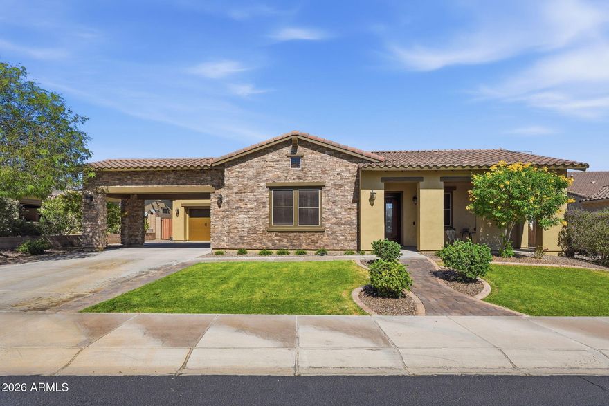 Located within the gated community of Aria at Vistancia, this coveted single-story showcases stunning stonework curb appeal, a covered carport, and spacious three-car garage. Step inside to an open-concept floor plan perfect for both everyday living and entertaining. The gourmet kitchen features granite countertops, beautiful cabinetry, a gas range, and abundant prep and storage space. A private den offers the perfect flex space for a home office or media room.

The expansive primary suite includes a walk-in closet and spacious ensuite bathroom. Step outside to a private backyard oasis with a sparkling pool, built-in grill, and covered paver patio -perfect for Arizona living. Residents enjoy access to resort-style amenities including pools, trails, tennis and pickleball courts, and more.