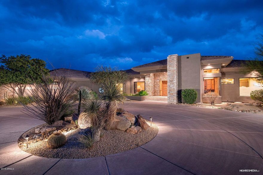 One of a kind Contemporary estate home with breathtaking mountain views. A private driveway with arched entrance bring you to this dream home. A high detailed ceiling greatroom opens to  floor to ceiling glass walls, endless stone flooring, private large dining room and full private bar allowing endless entertaining. A gourmet kitchen: commercial gas range, dual ovens, warming drawer, builtin refrigerator, vegetable sink, walk in pantry, island, breakfast bar all overlooking your greatroom with backyard McDowell Mtn views. Each en-suite bedroom,bathroom are fully appointed and detailed. The master bed and bath are a luxurious retreat. Step outside to your detach guest house, oasis negative edge pool and spa, flaming water features, and rock waterslide all under your endless 3.4 acre estate
