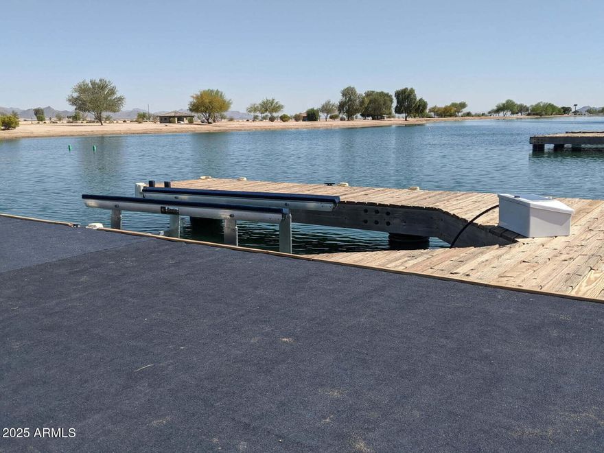 Rare opportunity to build a custom home and be on a private tournament waterski lake in the desert; This one acre lot comes with a boat dock, Basta boat lift already installed and a temporary rock driveway already in place. This lot faces East which is ideal in the summer months. The mountain views, sunrises and sunsets are Phenomenal! Make this your permanent residence or just your weekend getaway from the hustle and bustle of life!