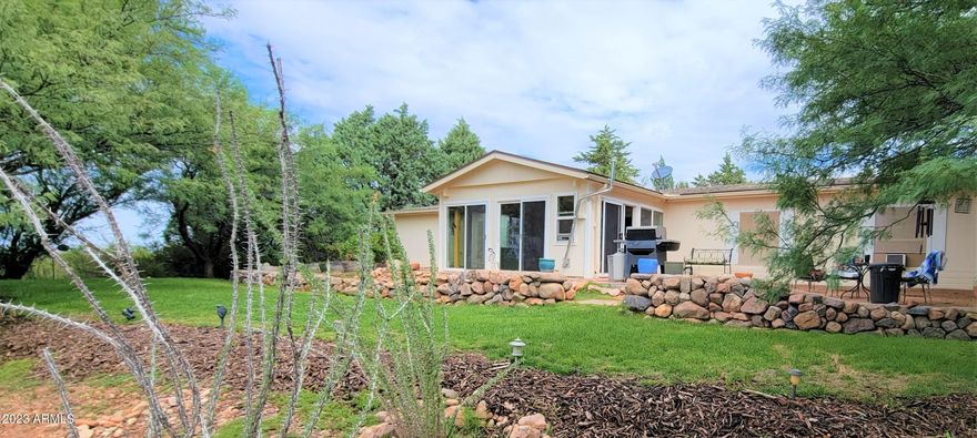 You will absolutely love this lovely pit set manufactured home on almost 4.5 acres on a hill overlooking the San Pedro Valley. The seller is installing a new VA foundation now. There is a 22X40 shop/ RV barn with 220 for all of your toys. There are also RV hookups outside. The home is reversed to take advantage of the wonderful views of the city lights and the Huachuca and Mule Mountains to the south. The landscaping is amazing to include mature cedar and fruit trees and Mexican Bird of Paradise. There is even a little area of grass. Everything in on a watering system to make this yard easy to care for. Step inside the Arizona room that has either a pellet stove in the winter or ac for the summer. The home features a wonderful floor plan with a large great room as well as a family room The kitchen has a great view to the landscaped front yard and there is a ton of counterspace. There is also a breakfast nook. The master is on the opposite side of the great room for privacy and there is a good sized master bath with a garden tub and a separate shower. The three other bedrooms are all good sized and there are ceiling fans thru out. They are wired for lights, so pick out your favorite light kit and install. There is a newer roof, windows, furnace and central a/c, flooring and much more. You will want to make this special home your own. The square footage includes the AZ room and it has a pellet stove for the winter and a window ac unit for the summer.
