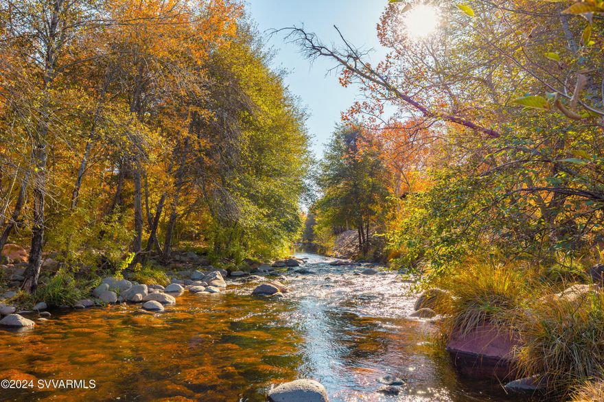 RARE Opportunity to own a piece of Oak Creek on a 2.57 Acre lot with Towering Pines & Sycamores. Very short walk to all the best Shops, Restaurants & Spas that Tlaquepaque & Uptown Sedona have to offer. House sits on a majestic 1.29 acres. Porch overlooks 166 ft of OAK CREEK FRONTAGE, dramatic Red Rock VIEWS above a personal swimming hole. The ADJOINING 1.28 acre LOT CAN BE SPLIT INTO SEPARATE PARCELS. NO H.O.A / SHORT TERM RENTAL FRIENDLY.  Ready for Guest house w pool, or Orchard/Garden of your dreams fed by WATERS OF OAK CREEK through Historic Owenby ditch IRRIGATION! Great room's floor-to-ceiling brick fireplace showcases lofty ceilings framed with expansive exposed wood beam trusses designed by Lee Christensen. Open kitchen with THERMADOR appliances and Taj Mahal Quartzite Counters. Indoor and outdoor spaces blend together seamlessly to create an entertainment masterpiece. Relax on the back patio and listen to the creek flowing past and the wind whispering in the Oak and Sycamore trees. Or sit the front patio fenced courtyard by the water fountain and take in the rose garden. Huge fenced storage area with access from the driveway has room to store all your outdoor adventure toys. Walk next door to Los Abrigados Resort and Spa where you can purchase a membership and enjoy Heated pools and Hottubs,  Spa services, fitness facility, pickleball, tennis, putt putt golf, the creekside park and restaurant.
 4 Spacious Bedrooms, 3 Baths. The Beautiful primary bedroom suite has a  huge custom walk-in closet, doors to a private patio and the spa-like ensuite  bathroom with dual vanities,  a luxurious soaking tub and a large walk-in shower with an original stained glass window of the Sedona red rocks.
Additional upgrades include mini-splits in all bedrooms for individual comfort preferences, LG Washer and Dryer, Smart Mirrors in all bathrooms, solar tubes, new Ecobee Smart Thermostats. Two car garage PLUS Parking for 6+ vehicles on the HUGE New paver driveway PLUS space for a RV Parking/Future RV Garage PLUS Space to custom build anything you can think of!
Owner is a licensed Real estate agent in the state of California.




.