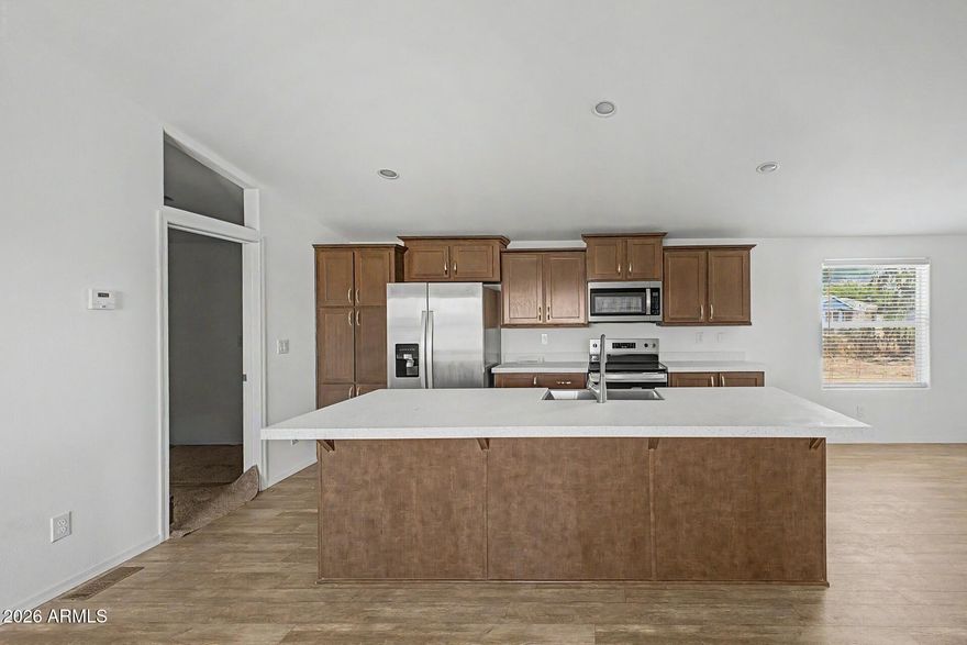 Beautiful brand-new 2026 manufactured home offering 4 bedrooms, 2 bathrooms, and 1,605 sq ft of bright, modern living space. The open-concept floor plan features a spacious living area, recessed lighting, vinyl flooring, and a stylish kitchen with an island, stainless steel appliances, and ample cabinet space. Both bathrooms showcase clean, contemporary finishes. Outside, enjoy more than an acre with plenty of room for parking, storage, or future outdoor ideas. Move-in ready and designed with low-maintenance living in mind, this property offers modern construction, fresh finishes, and generous indoor-outdoor space.