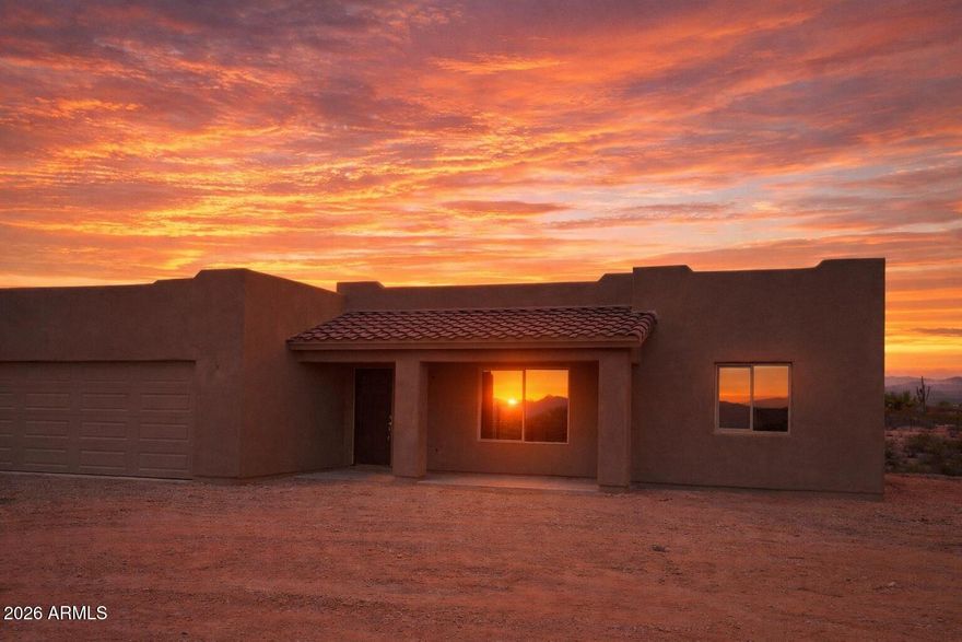 Welcome to your custom-built desert sanctuary, where the Arizona horizon stretches endlessly and equestrian dreams gallop into reality. No HOA. This meticulously crafted three-bedroom, two-bathroom residence has 1,428 square feet of thoughtfully designed living space, crowned by gleaming granite countertops and polished stainless appliances that transform everyday cooking into a culinary celebration. But the real magic unfolds beyond the front door. The privacy fence gives you the feeling of seclusion, while still a part a unique roping community. A sprawling 140 by 250 roping arena beckons seasoned riders and weekend cowboys alike, while the generous lot provides ample room for barns or additional corrals for the horses. The pull-through driveway accommodates large trailers with ease. Dedicated RV plugs ensure your adventurous spirit never stays parked for long. The surrounding Wittmann neighborhood offers proximity to numerous additional arenas, creating a vibrant equestrian community that feels both welcoming and wonderfully untamed. Lake Pleasant and countless recreational destinations lie within effortless reach, while the charming towns of Surprise and Wickenburg sit just fifteen and twenty minutes away, respectively. Quality construction meets boundless possibility on this exceptional property. Schedule your private showing before someone else saddles up and rides away with it.