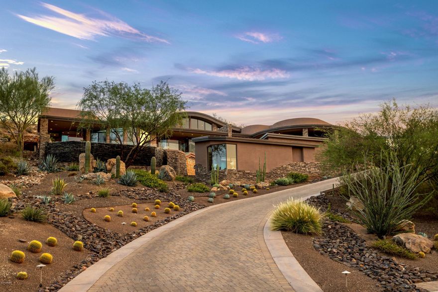 If you're looking for a sleek contemporary estate with jaw dropping views, look no further than this one of a kind custom home. Stunning hillside home features 2 bedrooms in the main house, plus an office, detached guest house with bedroom, sitting room and sauna, movie theatre, game room and so much more. Chef's kitchen with Neff cabinetry, Thermador range, spacious walk-in pantry and a built in cappuccino machine. Master suite boasts both mountain and city views with a pop-up tv, gas burning fireplace and spa-like master bathroom. For the car enthusiast, this garage does not disappoint!  Four stall garage with a pass through garage door and automatic glass entry door. Low maintenance yard with a negative edge pool to the front over looking the entire valley, spa... water wall, fire pit and beautiful courtyard with turf grass. Gorgeous outdoor kitchen to the back and a custom pizza oven chiseled into the mountain. Meticulous landscaping with picture perfect lighting to capture the home's beauty, even after dark. All of this as well as 4KW OWNED solar! Wonderful hiking trails all around. Don't let this one of a kind property pass you by.