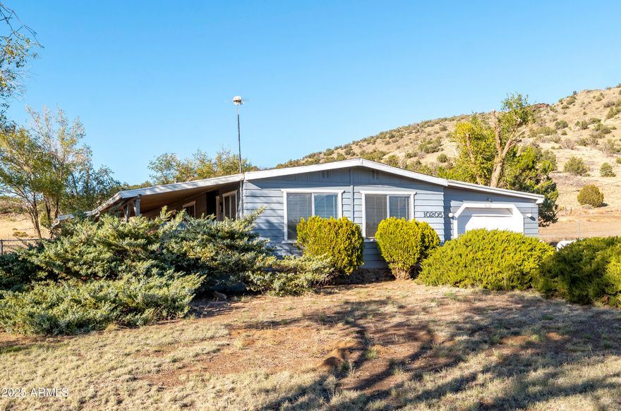 Experience the classic country lifestyle in this 66 x 24 double-wide 2/2 1584 sq. ft. home on 2.27 acres bordering the National Forest Service. Enjoy easy access to biking and horseback riding trailheads while exploring O'Neal Crater and the surrounding land listed on the historic register out the back door! Relax and enjoy breathtaking sunsets and wildlife viewing from your covered deck overlooking the San Francisco Peak mountain range. The property includes a workshop with 220V outlets, an attached two-car garage, a large separate garage, and a shed, making it ideal for DIY projects and storing outdoor gear for mountain adventures. Additionally, a custom-designed bunker shelter provides security and versatility. Discover the outstanding lifestyle this exceptional home on acreage offers!