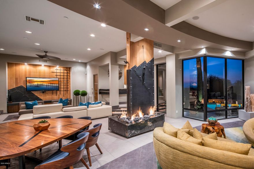 An extraordinary property tailored to perfection for contemporary living. Designed to flow over two levels, the entire home emanates sleek linear lines and large geometric volume, resulting in vast living and ample accommodation for friends, family and guests. Favorably located within the gated community of Pinnacle Canyon and drenched in North Scottsdale views, it's more than just a home, it's a work of art. 
Catering to those looking to live, work and play in an extraordinary space, the residence offers over 8400 SF of spaciousness. The kitchen is equipped to the highest standards with sleek cabinetry and top-of-the-line appliances that will satisfy the most demanding epicure. Impressive entertaining includes theatre room, multiple lounge areas and entire lower level dedicated to relaxation. Thoughtfully appointed within a spectacular backdrop of privileged views, the home is a showpiece of glamour and contemporary sophistication. Complemented with multiple living and dining areas that strike the perfect balance between entertaining and privacy, the superb attention to details appeal to the most discriminate buyer.
The sprawling outdoor space is a magnet for family fun, the perfect spot for gathering with friends, or an evening of quiet conversation. Enjoy the luxury and scale of a five-star hotel while watching the night skies sparkle. Tailored to indulgent comfort with an unparalleled capacity to entertain  a true feast for the eyes. Cosmopolitan living and a coveted address.
