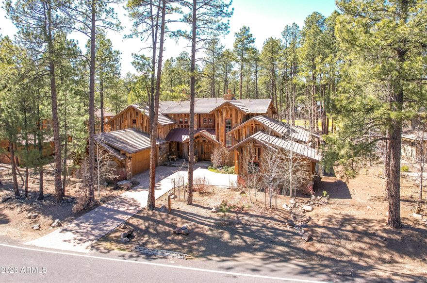 Rustic elegance perfectly situated with panoramic golf course views of the 15th hole. This 4,580 sq ft home pairs timeless character with modern comfort. The luxury home builder built this home for himself! Therefore, close attention was given to quality and details throughout! The 100-year-old oak barnwood exterior and exposed beams create warm, historic charm that flows into finely detailed interiors. Four bedrooms plus a bonus room and a private office provide flexible living space for family and work. Custom appointments elevate every space: a chef's kitchen with premium finishes, spectacular bar, refined powder room, and a dramatic fireplace that anchors the great room. The primary suite is a serene retreat with a steam shower and jacuzzi on the private deck. Practical amenities include two new water heaters, 3-car garage space with custom built-in cabinetry, and a dedicated wine room--ideal for collectors and entertaining. A thoughtful blend of rustic materials and upscale finishes makes this home a true statement of rustic elegance.
