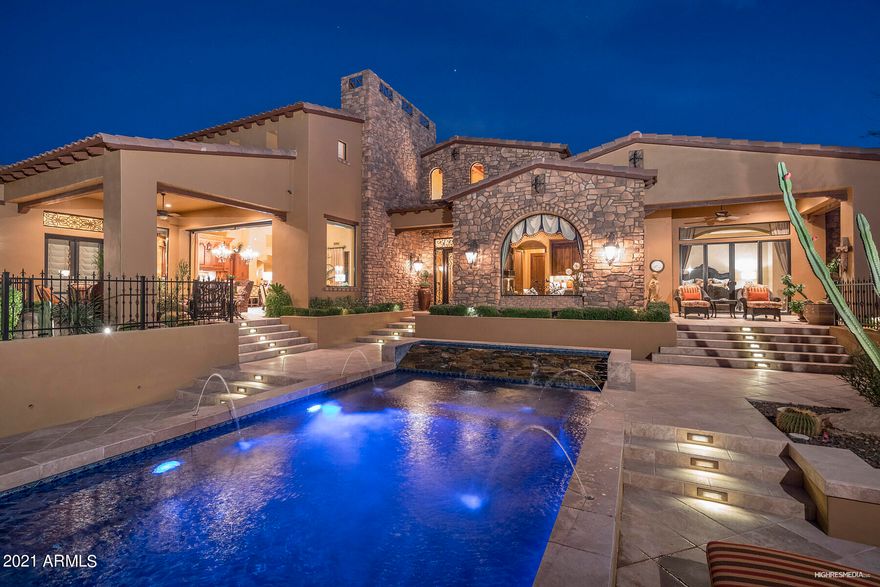 Stunning Mediterranean estate exquisite curb appeal, is nestled on a desirable elevated N/S exposure, oversized corner lot, in the exclusive demanded community of Las Sendas. Architecture rich this well-designed MASTERPIECE is focused on deliberate detail maximizing views of Red Mountain and seamless indoor/outdoor living & functionality. You CANNOT FIND a finer built home, inside and out! Four en-suite bedrooms/baths plus designated office w/spectacular views, powder room, and 2nd office in loft!. Amazing game room w/bar, teen TV room. Limitless living opportunities w/glass automated doors & blinds opening to seamless outdoor living w/outdoor chef's kitchen, fireplaces,  negative-edge pool w/water features & fire pots! Enjoy the Private Heated spa outside Master Bedroom door! (More.... Walk in this iron door entry to Sensational soaring 20 ft. ceilings w/wooden beams throughout. Finest of fabric custom draperies and valances throughout the home.  The kitchen and Bar area have amazing slabs of granite carved from around the world w/2 sinks.
Sub-Zero 72" refrigerator, gourmet Wolf gas range, warming drawer, dbl. ovens, microwave etc. Custom black steel exhaust hood over Gas stove. 2nd Dishwasher found in Wet bar and several beverage refrigerators through the home! VENETIAN PLASTER WALLS and ceilings ONLY SEEN IN THE FINEST OF HOMES! Sitting on almost 3.5 acres of land (Lot alone is worth $750K+) There is potential to add perhaps a casita behind the home or extra parking, a large "man cave" or anything else with HOA approval of plans.
Roof Deck is easy access from back patio with city light views where you can enjoy yet a 3rd fireplace and beverage refrigerator for entertaining.
Misting system cools the back patio at time of need.
Huge Chef's OUTDOOR kitchen area with Gas BBQ, Beverage Refrigerator and added cooking features exist.
3 zoned Air Conditioners exist for optimum cooling. Blown in cellulose in all exterior walls. Automatic Sunscreens on inside of house for all windows facing North to keep totally private home and efficiency in heating and cooling. Whole house audio/music system in essential areas both inside and out for optimum entertainment! Executive office has built-in Murphy bed for extra company!
This home truly trumps many in Scottsdale and Paradise Valley areas at 1/2 the price on market yet sits at 1800 Ft. Elevation in the Phoenix Valley backing to the Tonto National Forest! 22 minutes to Sky Harbor Airport, Mins. to all shopping and still only 15 minutes to Saguaro or Canyon Lakes for boating and water sports!  
You won't find a better place to live in the valley!  Las Sendas Master planned community offers, 2 Community Pools (one heated year round)tons of tennis courts, (6) pickleball courts, basketball courts, splash pad for the kids, soccer and baseball fields....and the Trailhead Club which is home to an excellent private spa/fitness center (separate fee) all for only $121.96 per month HOA dues!
Then add one of the top ranked Semi-Private Golf Courses in the State....Walk over to the clubhouse/restaurant and 18 holes of perfectly maintained paradise! Call for golf and membership rates.