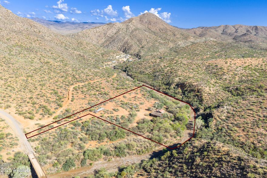 Situated in the high desert with an old gold mine (Vulcan No. 1 Lode), this 5 acre horse property offers a scenic backdrop with mountain views and directly adjacent to the seasonal Turkey Creek and Prescott National Forest! Access is directly off the Crown King Rd and only a few minutes from the charming town of Cleator. There are 2 old buildings on site with one built in 1936. The property comes with mineral rights (gold & silver) so dust off the gold pan and scratch that gold itch! There's a hand dug well with water at 50'.  Power is on site but not active. Enter property at your own risk. There can be hazards. There is an historic arrastra north of the house and plenty of room for horse/ranch/livestock facilities. The adjacent property is also for sale.
